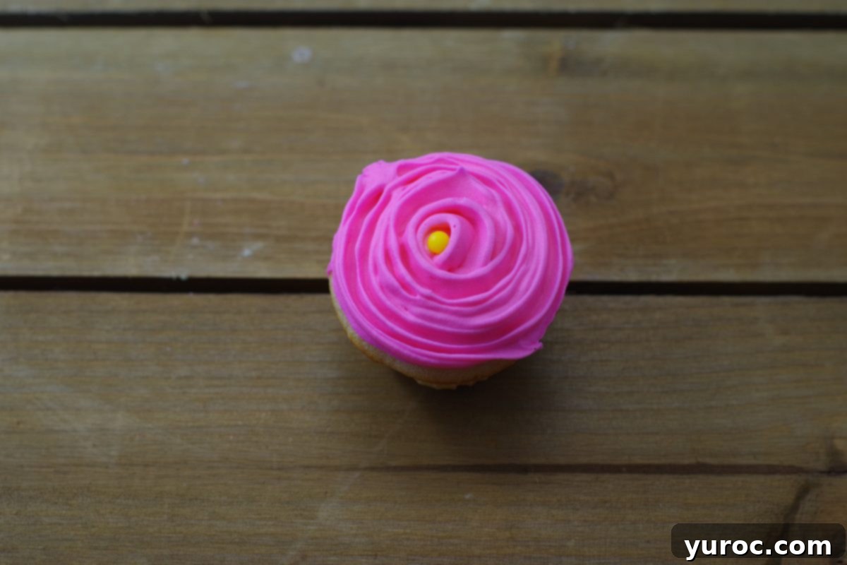 Sweet Seedlings 11 Beautifully iced flower cupcake with a rose swirl pattern.