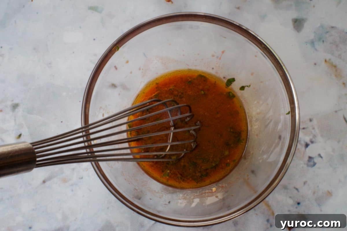 All Clamato dressing ingredients whisked together in a bowl.