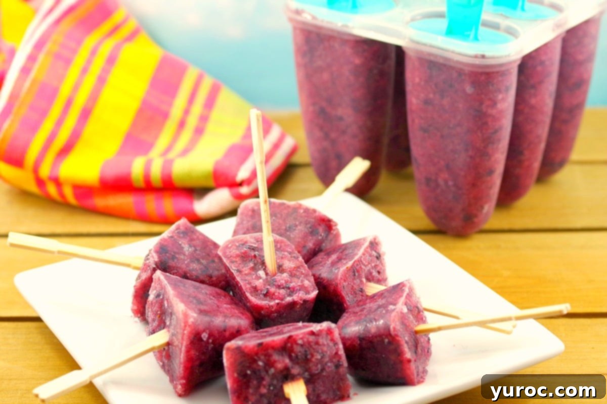 Close-up of three colorful sugar-free ice pops made from pure fruit, showcasing their natural beauty and healthy appeal.