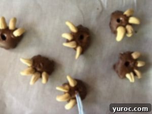 Illustrative image showing a straw being used to poke a hole through a softened chocolate garnish for the Bear Claw milkshake.