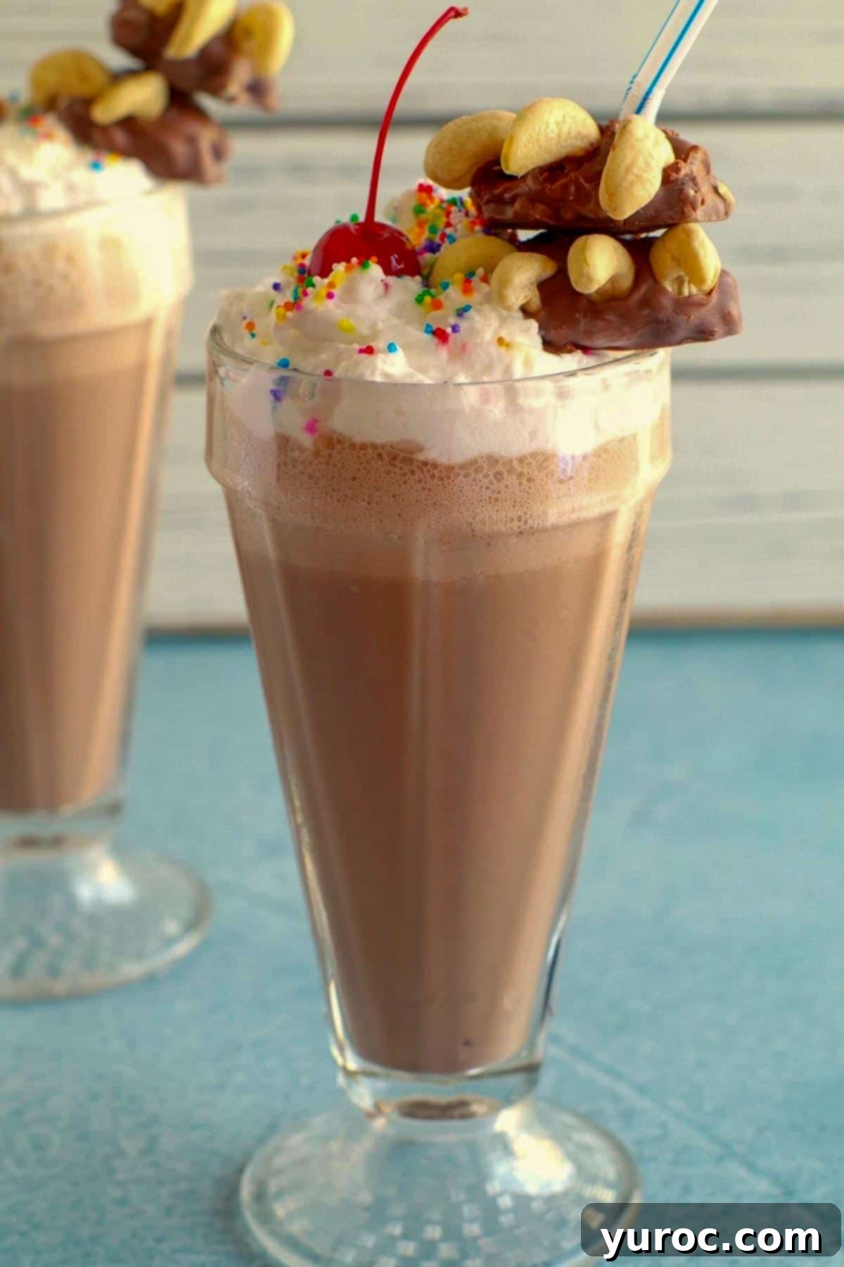 Two enticing chocolate caramel milkshakes adorned with Bear Claw garnishes, ready to be enjoyed.
