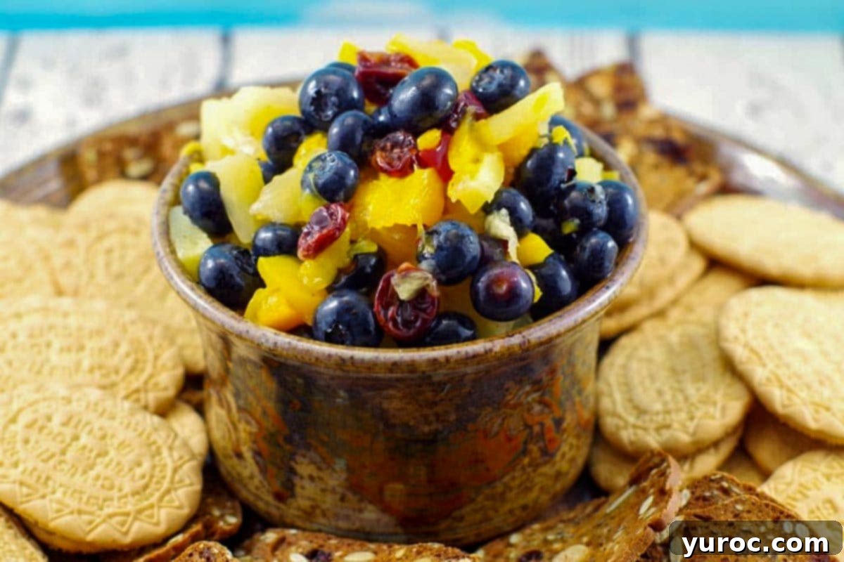 Sun-Kissed Peach Pineapple Salsa 2 pineapple peach fruit salsa in a brown dip bowl on platter with cookies around it
