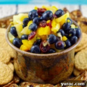 Sun-Kissed Peach Pineapple Salsa 5 pineapple peach fruit salsa in a brown dip bowl on platter with cookies around it