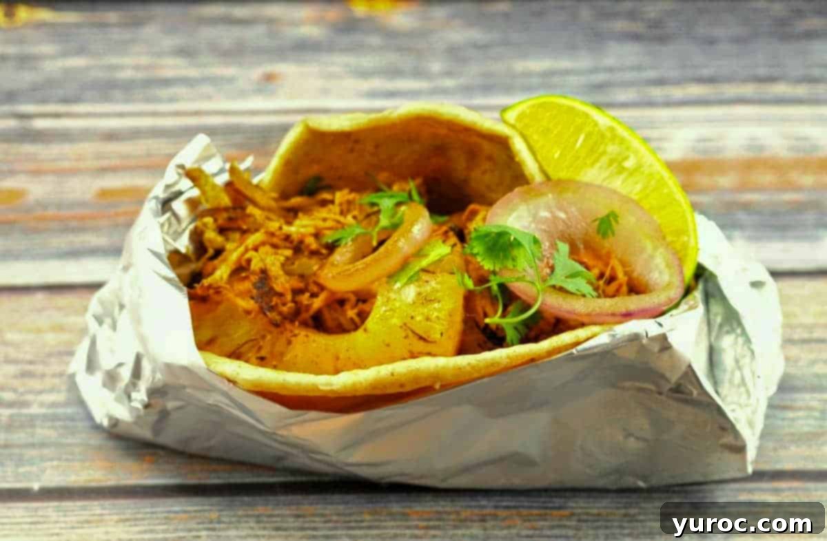 Pork Pineapple Carnita wrapped up in foil so it can be eaten on the go!