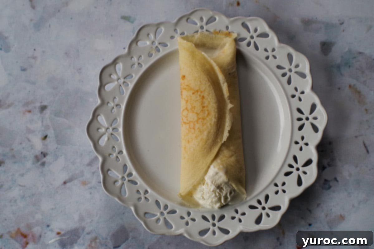 The other side of the crepe folded towards the middle to cover the ice cream.