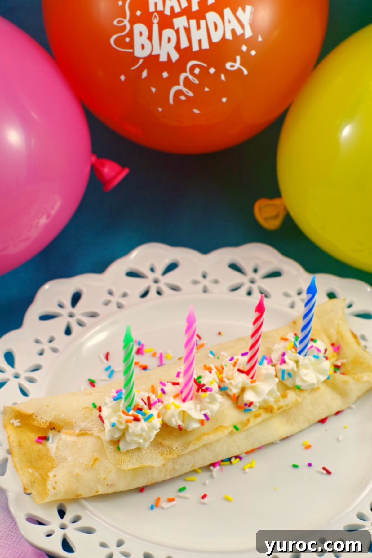 Layered Birthday Cake Batter and Ice Cream Crepes with a birthday candle.