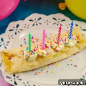 Birthday Cake Batter and Ice Cream Crepes on a white plate with balloons in the background