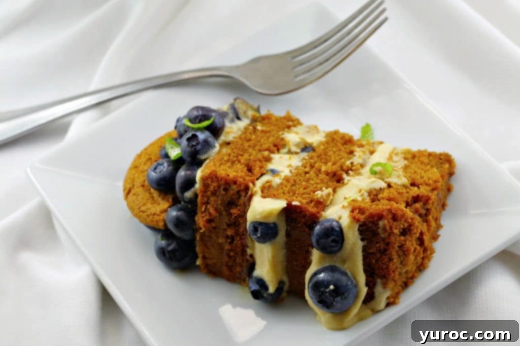 Close-up of old-fashioned gingerbread cake layers with cookie butter filling ingredients laid out, including fresh blueberries and spices, ready for baking.