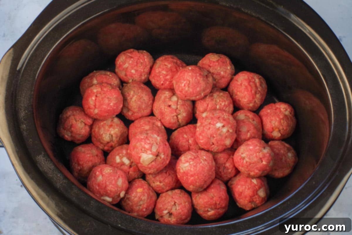 Sticky Sweet and Sour Slow Cooker Meatballs 7 Formed meatballs placed in slow cooker.