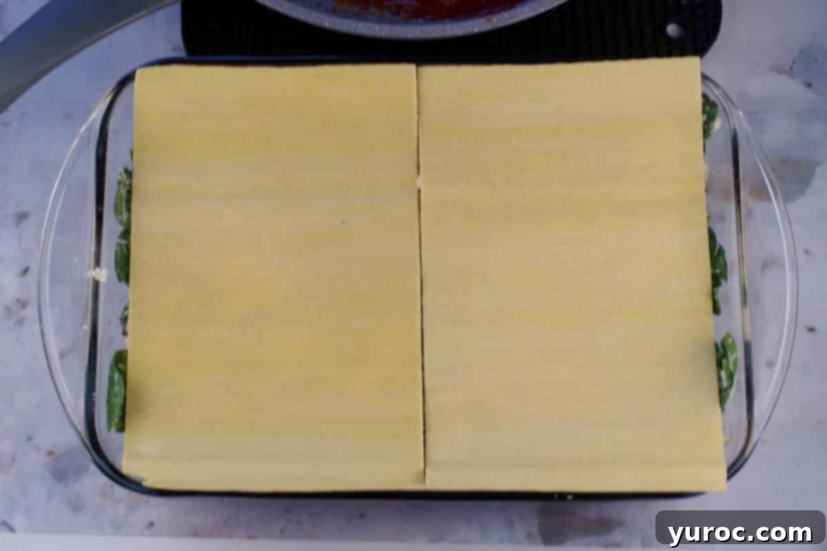 Prep-Ahead No-Boil Lasagna 10 Second layer of lasagna noodle sheets placed on top of the cheese mixture