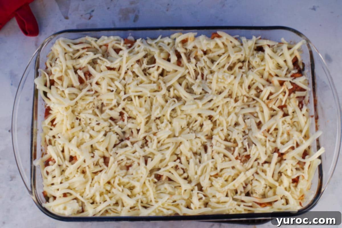 Prep-Ahead No-Boil Lasagna 13 Lasagna covered with a generous layer of shredded mozzarella cheese