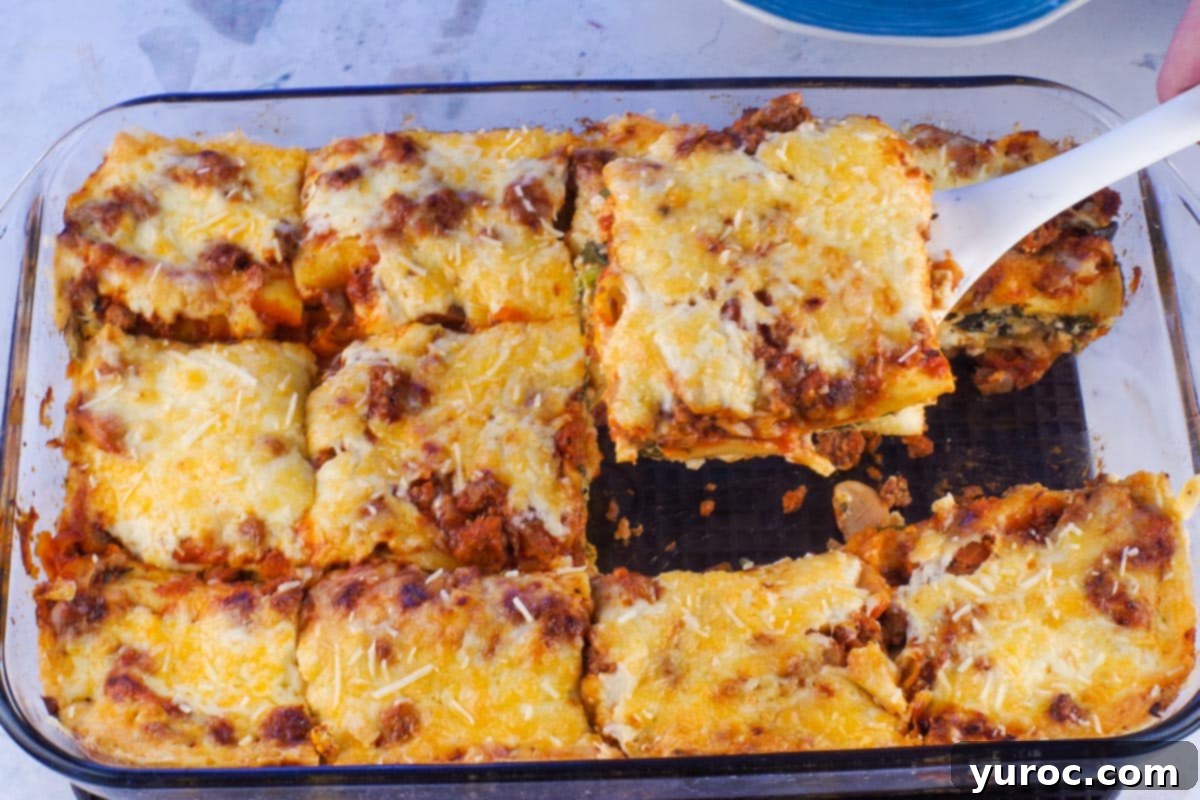 Prep-Ahead No-Boil Lasagna 15 Make-ahead lasagna being served from a glass dish with a spatula, showing a perfectly portioned slice