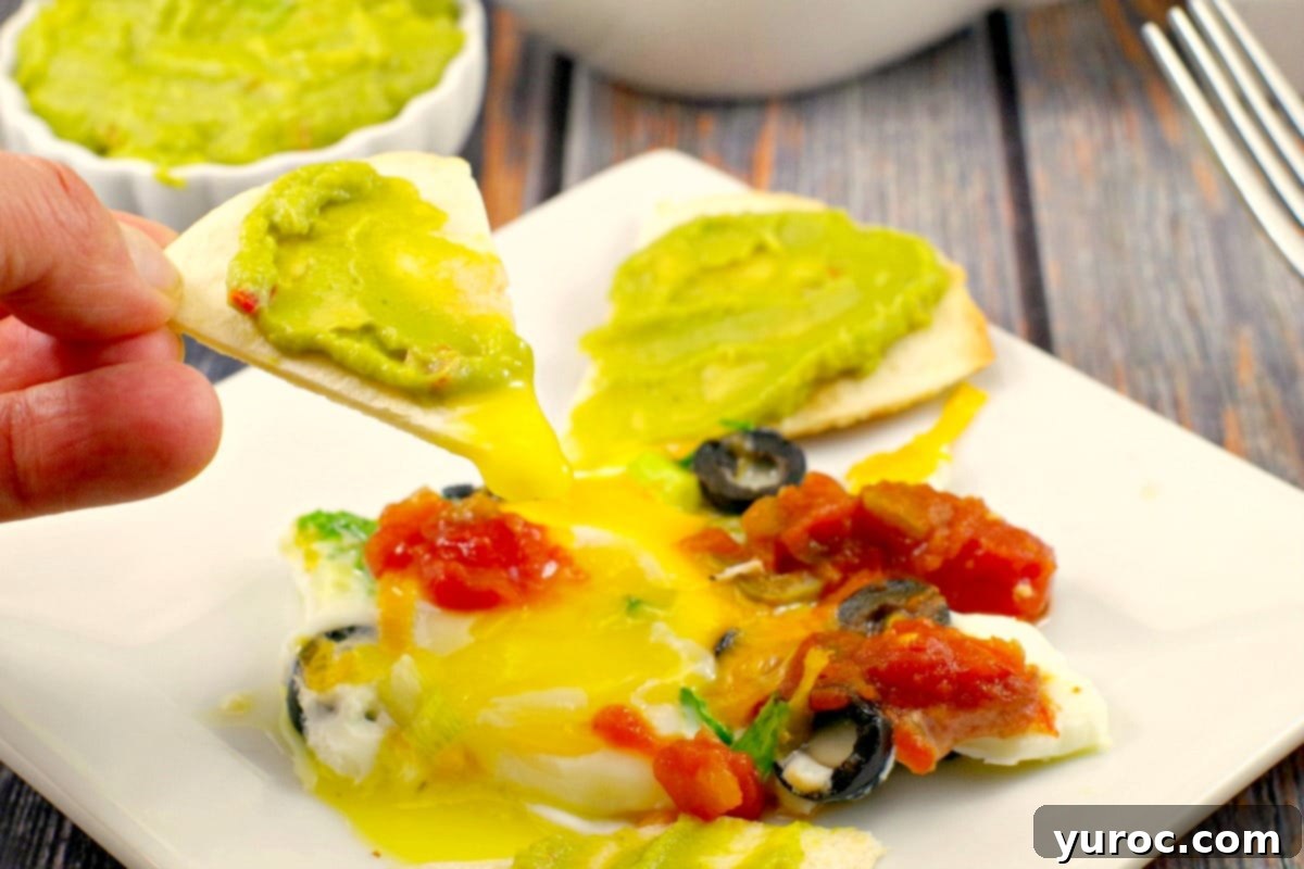One-Pan Mexican Fried Eggs 5 Overhead view of a Sheet Pan with cooked Mexican Eggs and toppings