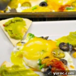One-Pan Mexican Fried Eggs 6 one sheet pan mexican egg on a plate with tortilla toast and sheet pan with more eggs in the background
