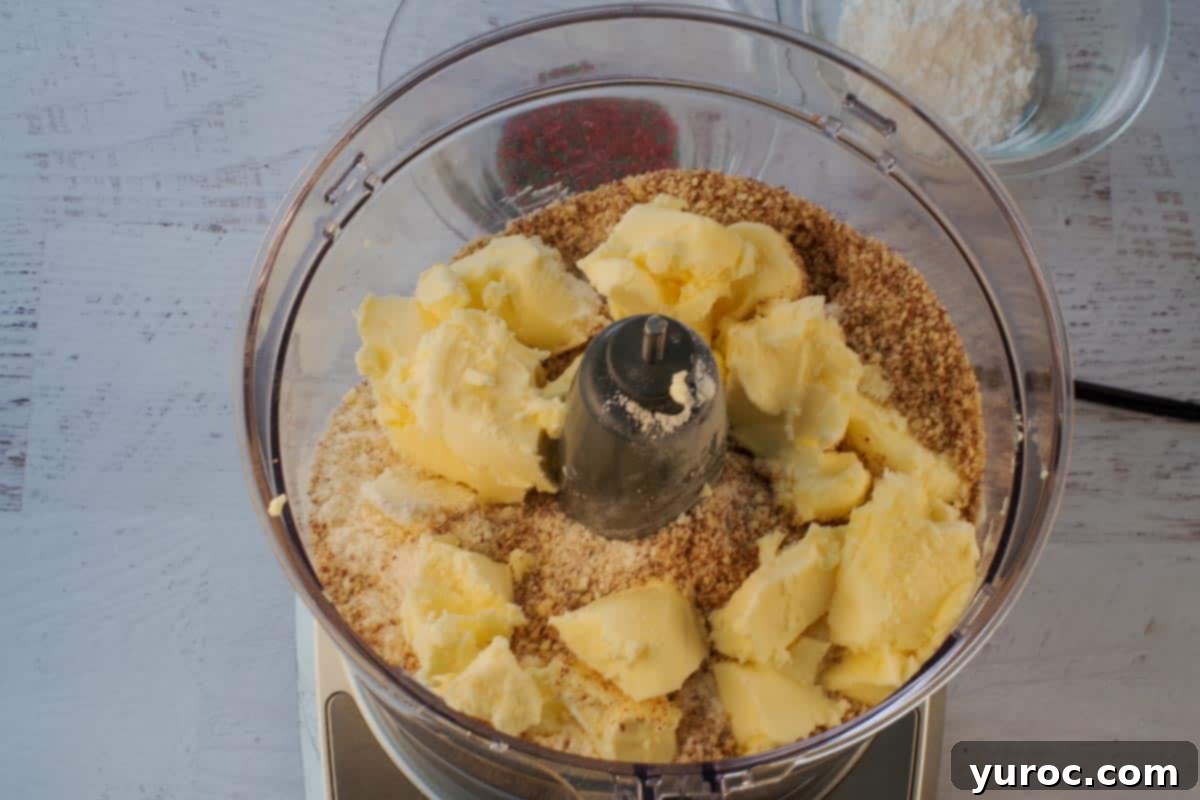 Winter Spice Almond Snow Puffs 6 Ingredients for Almond Snowball Cookies being mixed in a food processor.