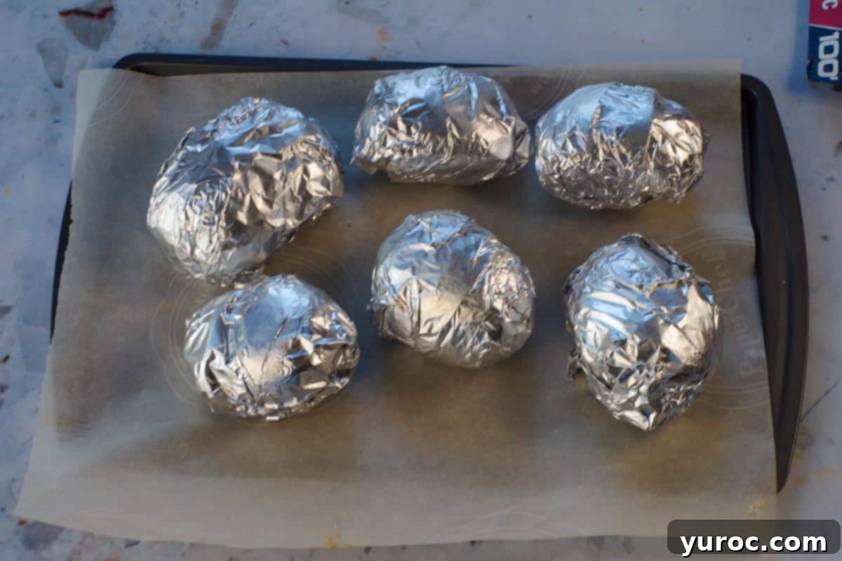 French Onion Baked Potatoes 7 6 Potatoes wrapped in foil on a parchment lined baking sheet