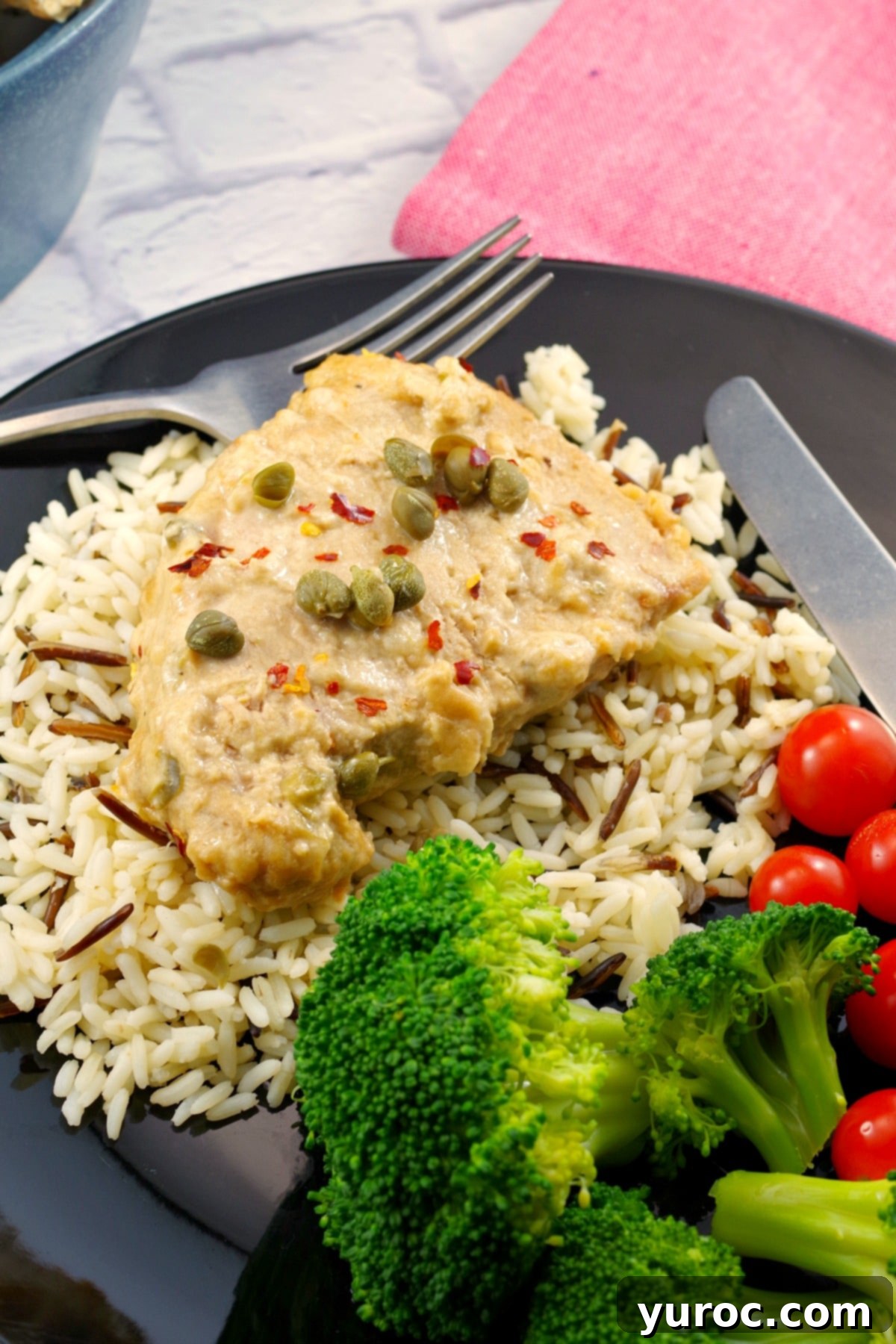 Creamy Mustard Caper Pork 5 Plated Weight Watchers pork with creamy mustard caper sauce, served over a bed of rice, accompanied by a fresh green salad and cherry tomatoes for a balanced meal.