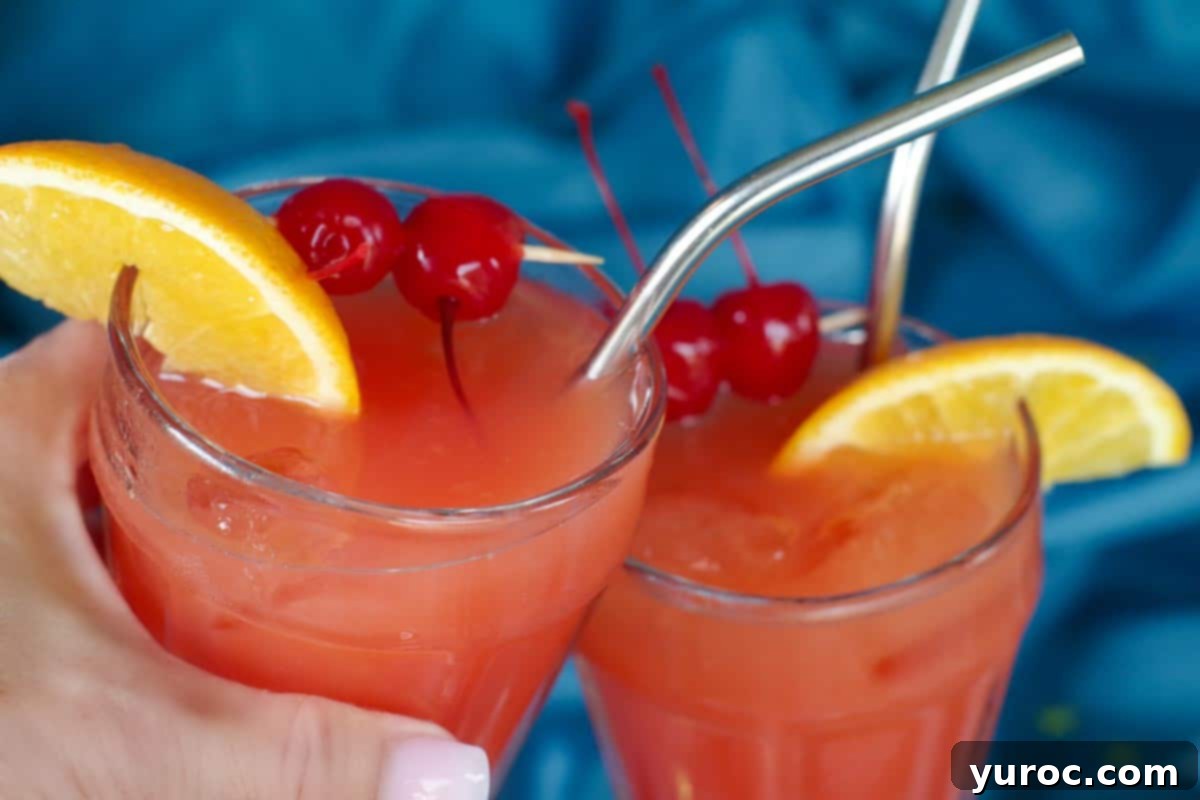 Shirley Temple Mocktail Recipe 1 Two glasses of Shirley Temple Mocktails being clinked together in celebration
