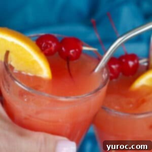 Shirley Temple Mocktail Recipe 11 Two glasses of Shirley Temple Mocktails being clinked together