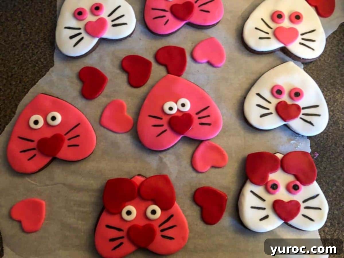 Purr-fect Heart-Shaped Cat Treats 7 cat cookies with ears, eyes and faces drawn on