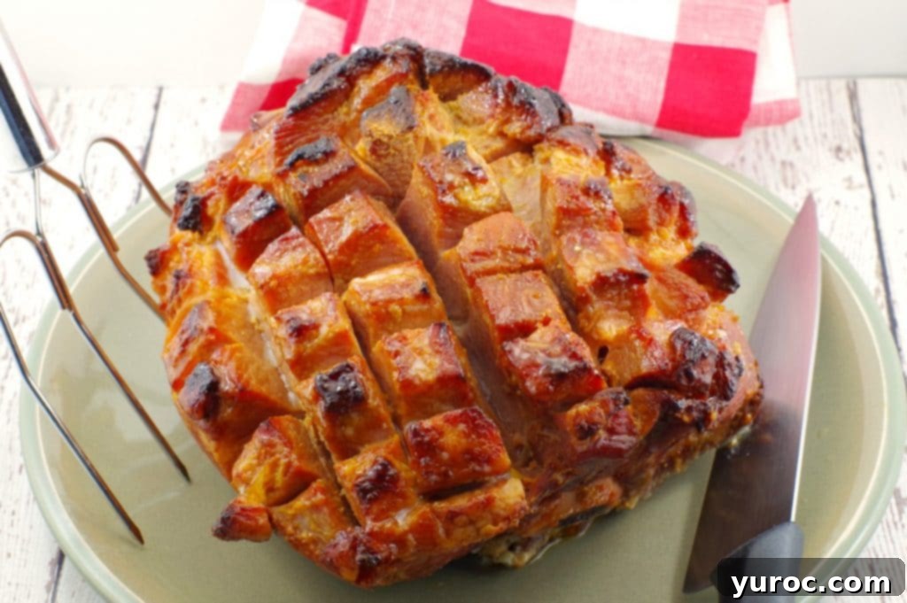 Whole, scored and cooked picnic ham on a plate