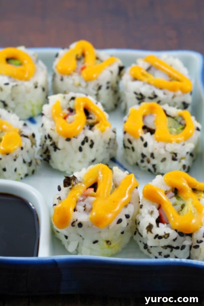 9 California rolls in a sushi dish with sriracha mayonnaise swirled on top