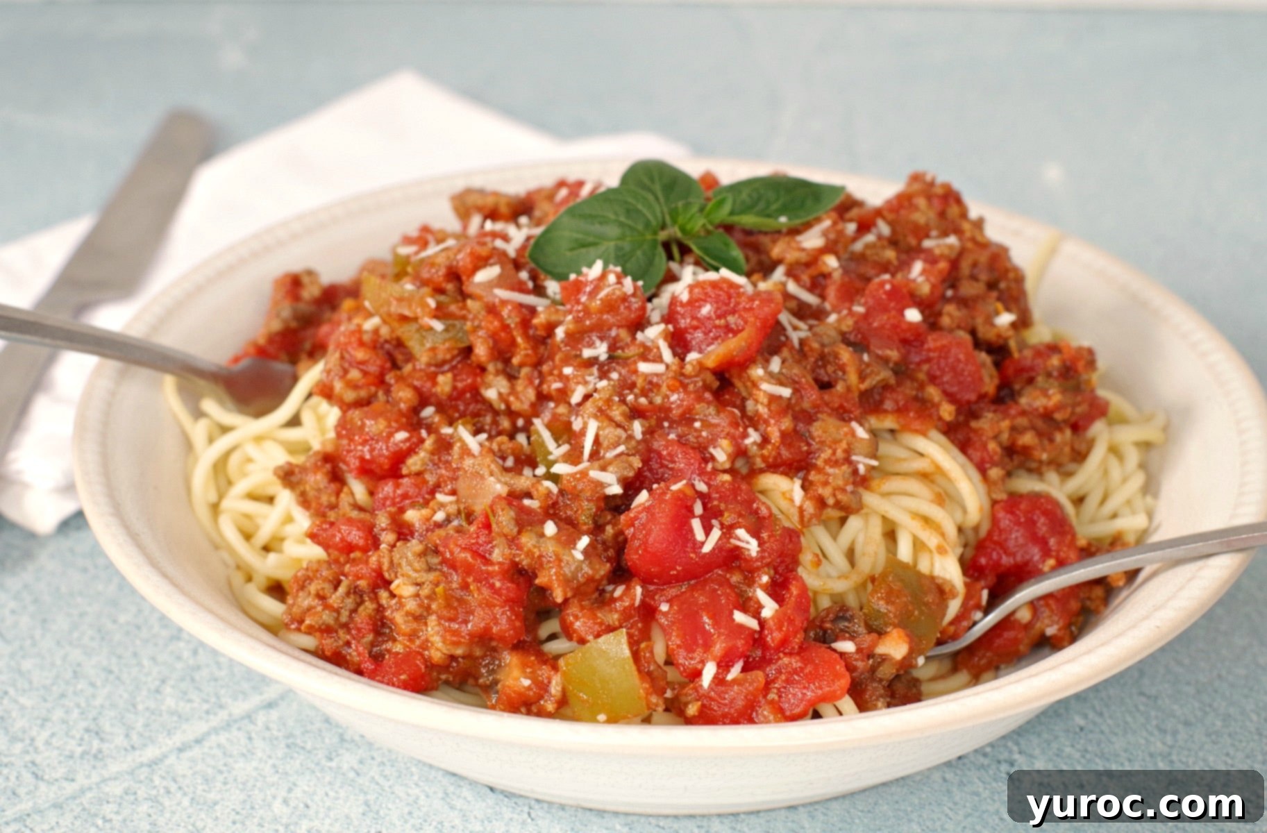 Spaghetti and meat sauce served in a bowl, ready to eat
