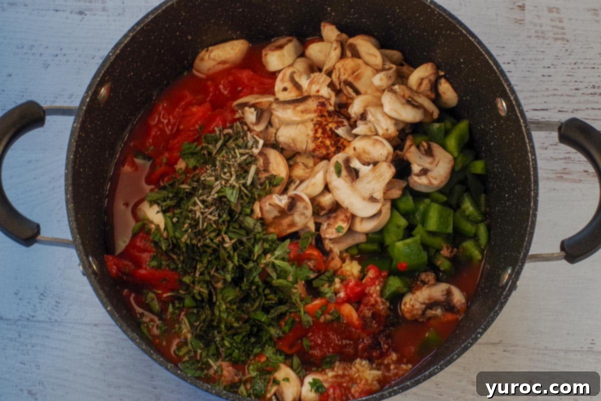 Various ingredients for spaghetti sauce, including tomatoes, peppers, and spices, combined in a large pot