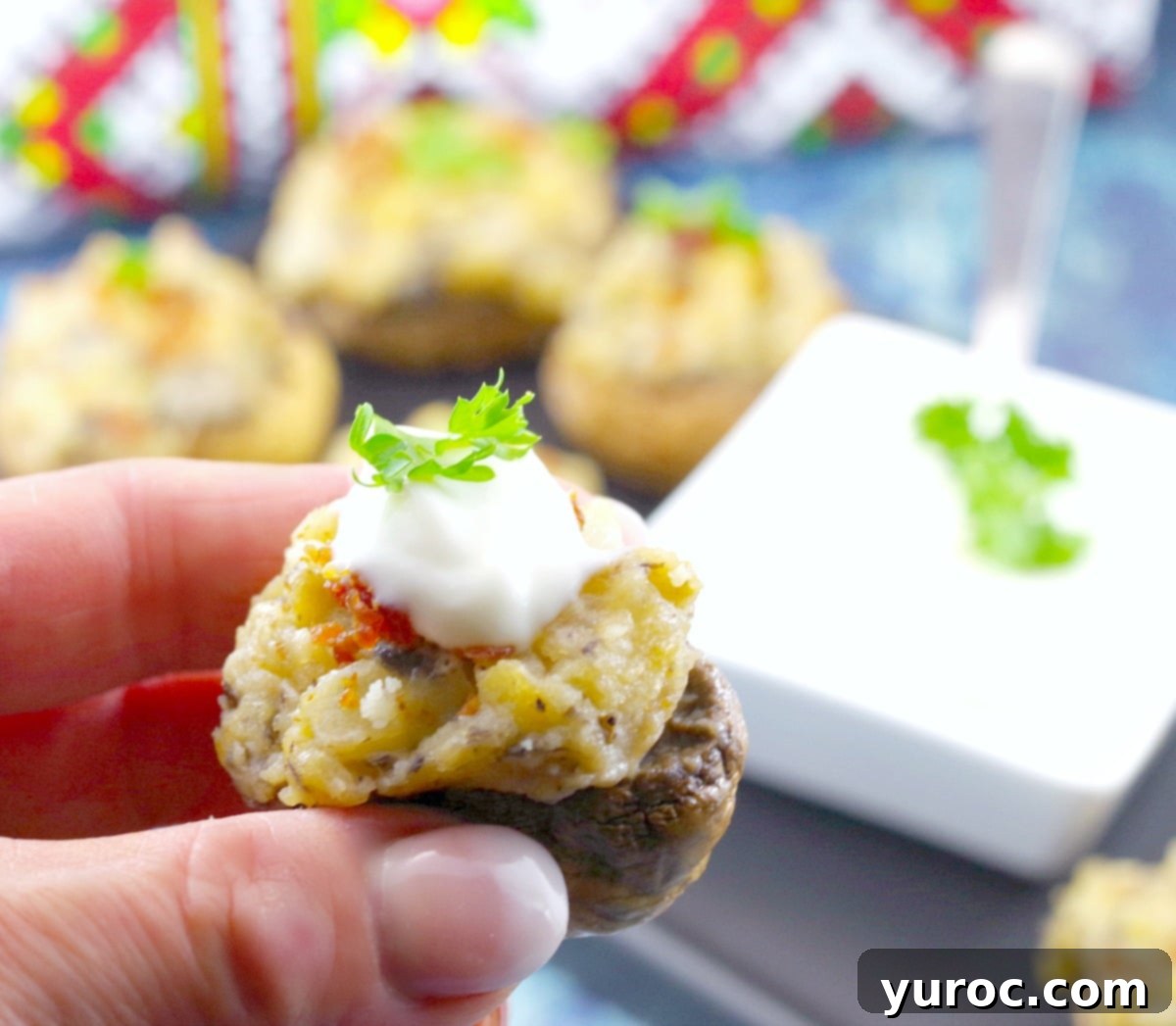 Pierogi Mushroom Bites 3 A single Potato Pierogi Stuffed Mushroom held between fingers, showcasing the delicious potato filling