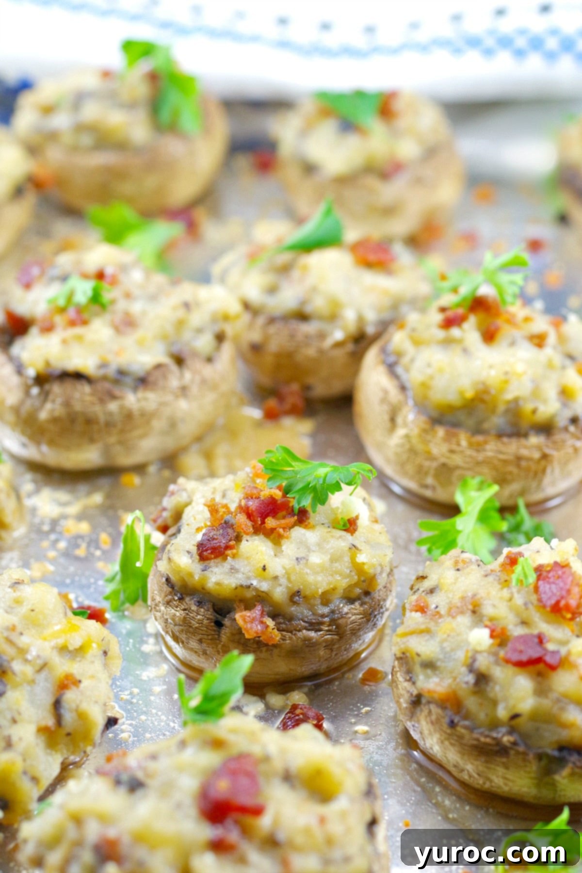Pierogi Mushroom Bites 7 Pierogi stuffed mushrooms arranged neatly on an aluminum foil-lined baking sheet, golden and inviting