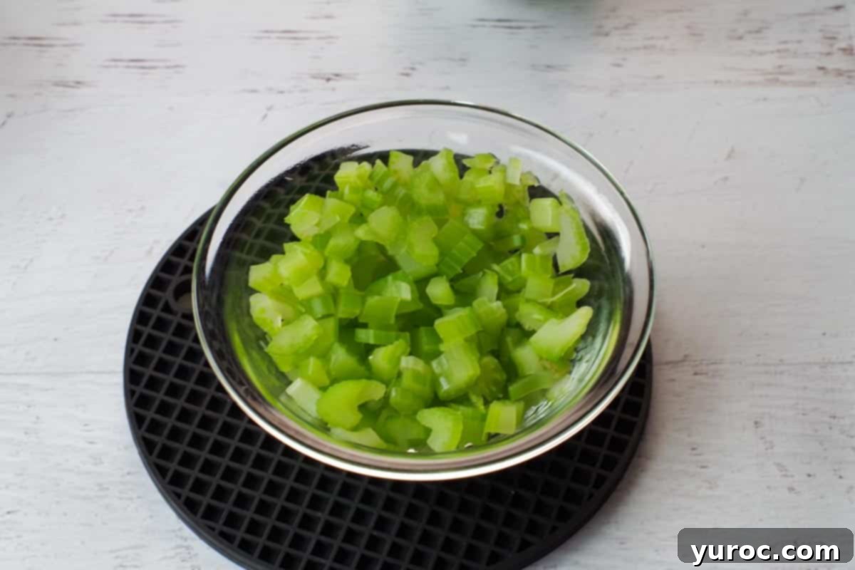 Hearty Chow Mein Hotdish 5 Chopped, cooked celery in a glass bowl, ready to be added to the hotdish mixture.
