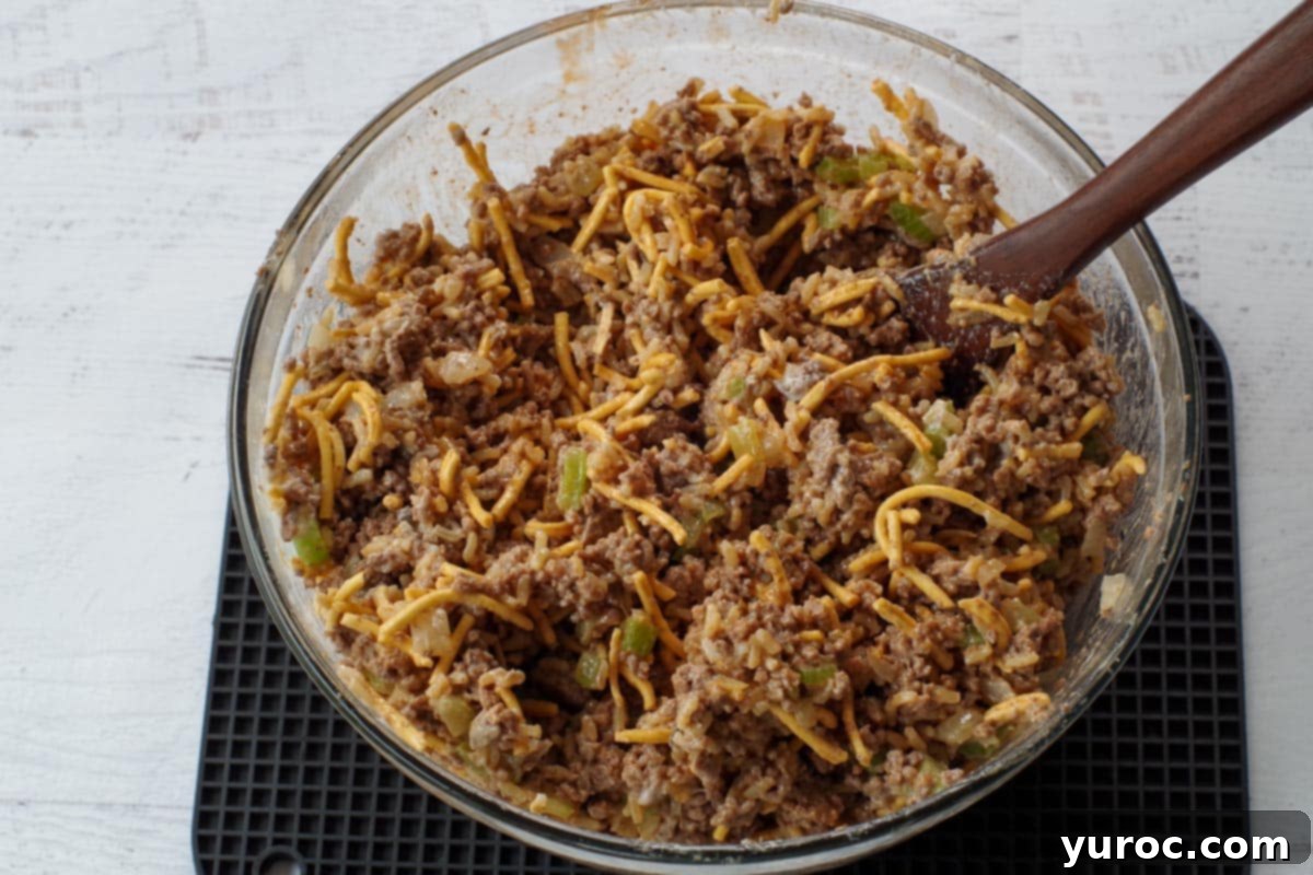 Hearty Chow Mein Hotdish 7 All Chow Mein Hotdish ingredients mixed together in a large mixing bowl before transferring to a baking dish.