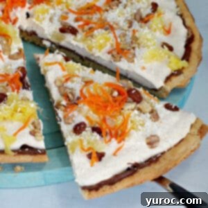 carrot cake dessert pizza slice being removed from pizza