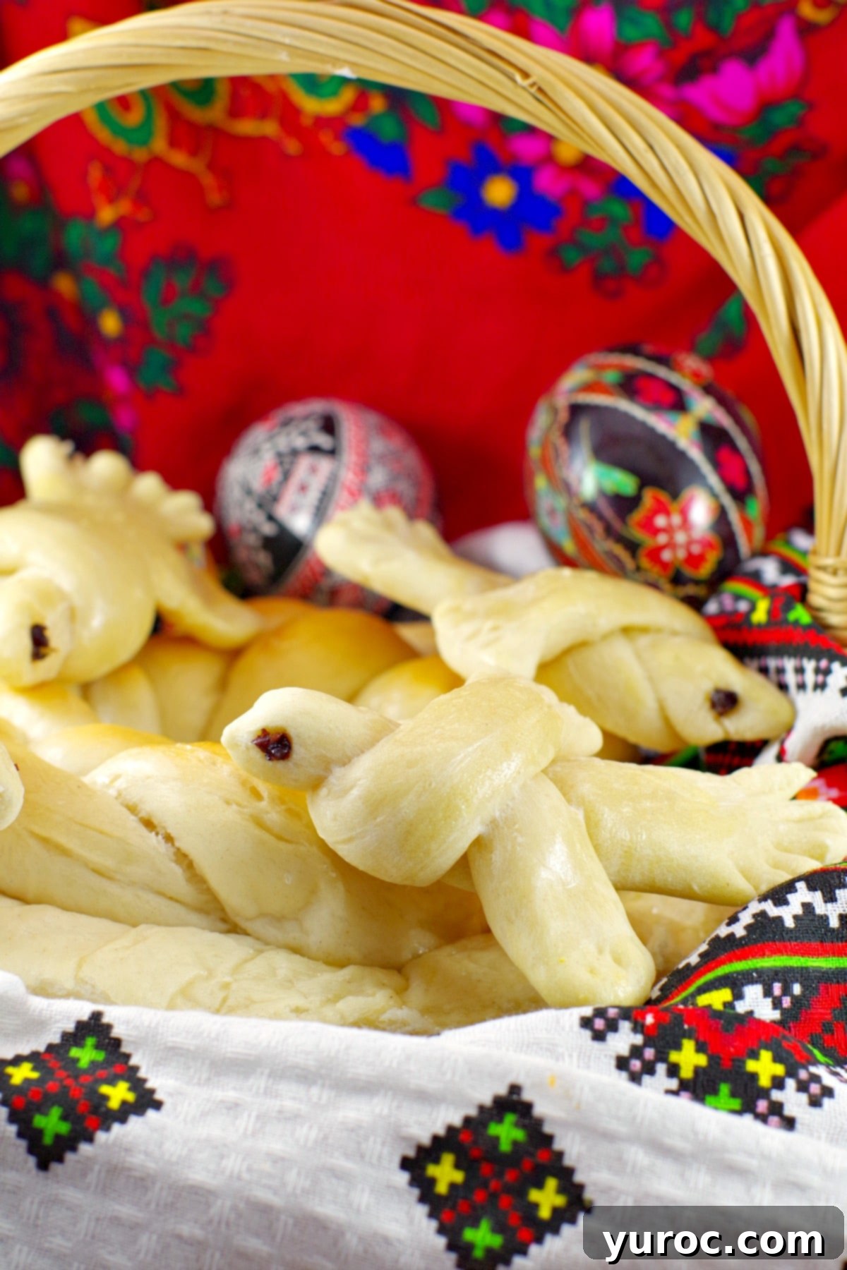 Ukrainian Easter bread doves in basket with Ukrainian Easter Eggs in background
