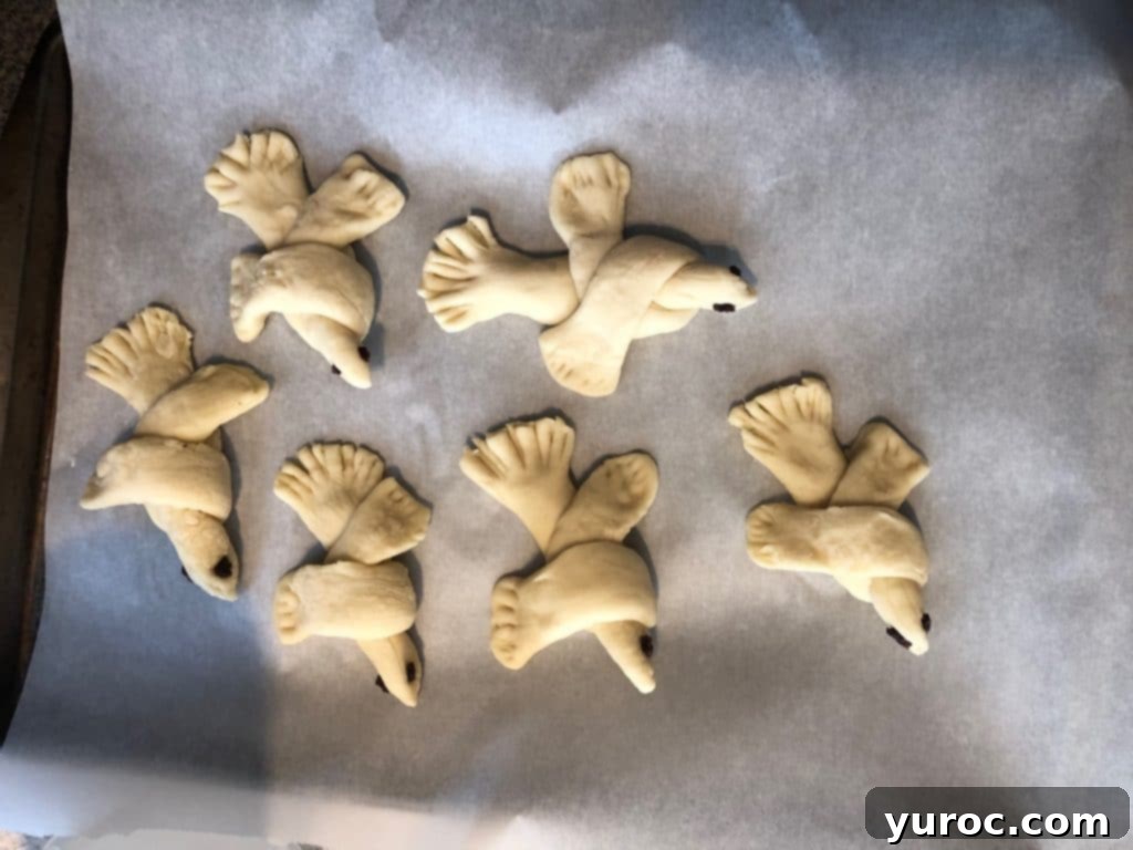 bread doves on parchment lined baking sheet