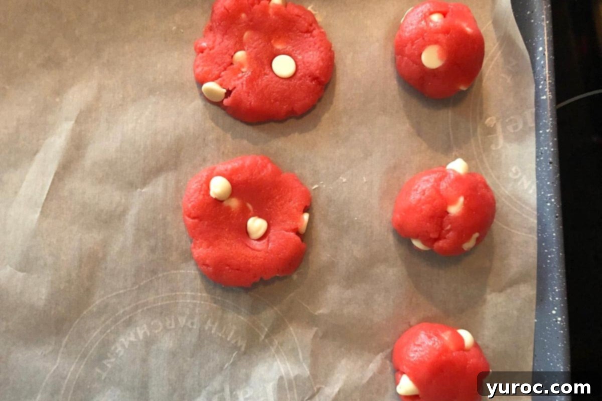 Dreamy Strawberry Milkshake Cookies 3 strawberry milkshake cookie dough rolled into balls and flattened on a parchment lined cookie sheet