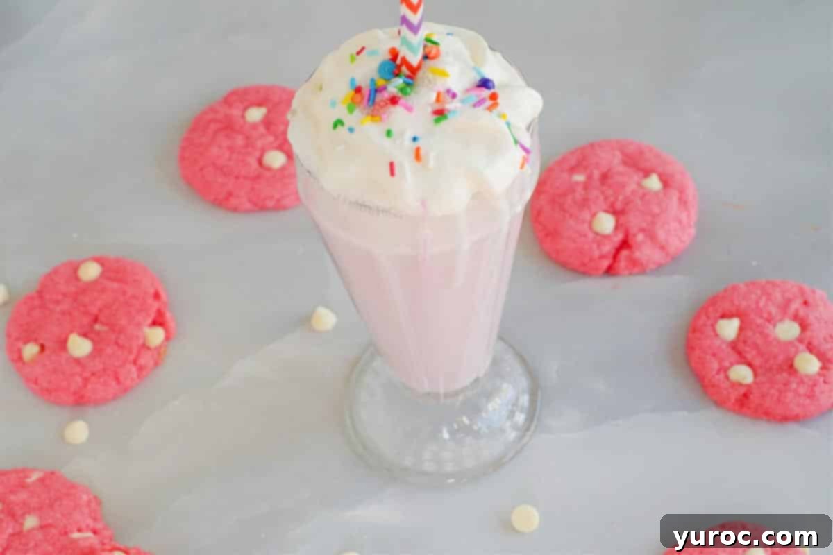 Dreamy Strawberry Milkshake Cookies 4 strawberry milkshake cookies in a circle around a strawberry milkshake (on grey marble background)