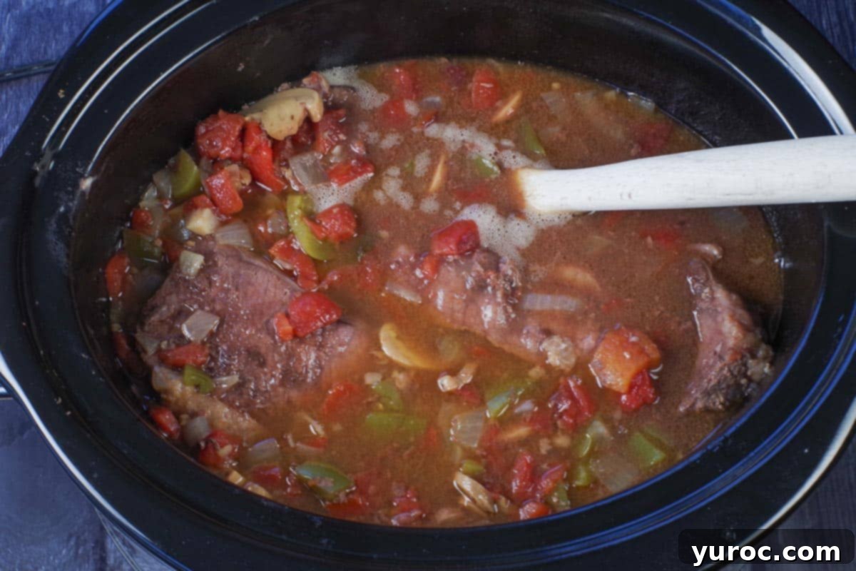Slow Cooker Smothered Swiss Steak 8 cooked swiss steak in a slow cooker
