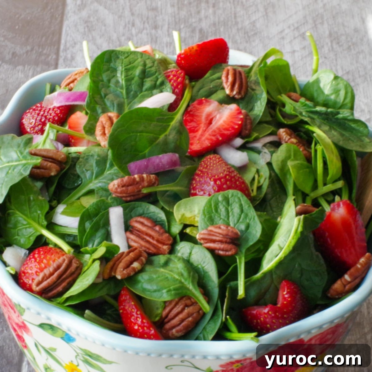 Slow Cooker Smothered Swiss Steak 10 strawberry spinach pecan salad in a large bowl with flower print and wooden utensils
