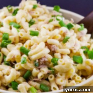 Wholesome Tuna Macaroni Salad 11 Healthy Tuna Macaroni Salad without peas in a bowl with a serving spoon.