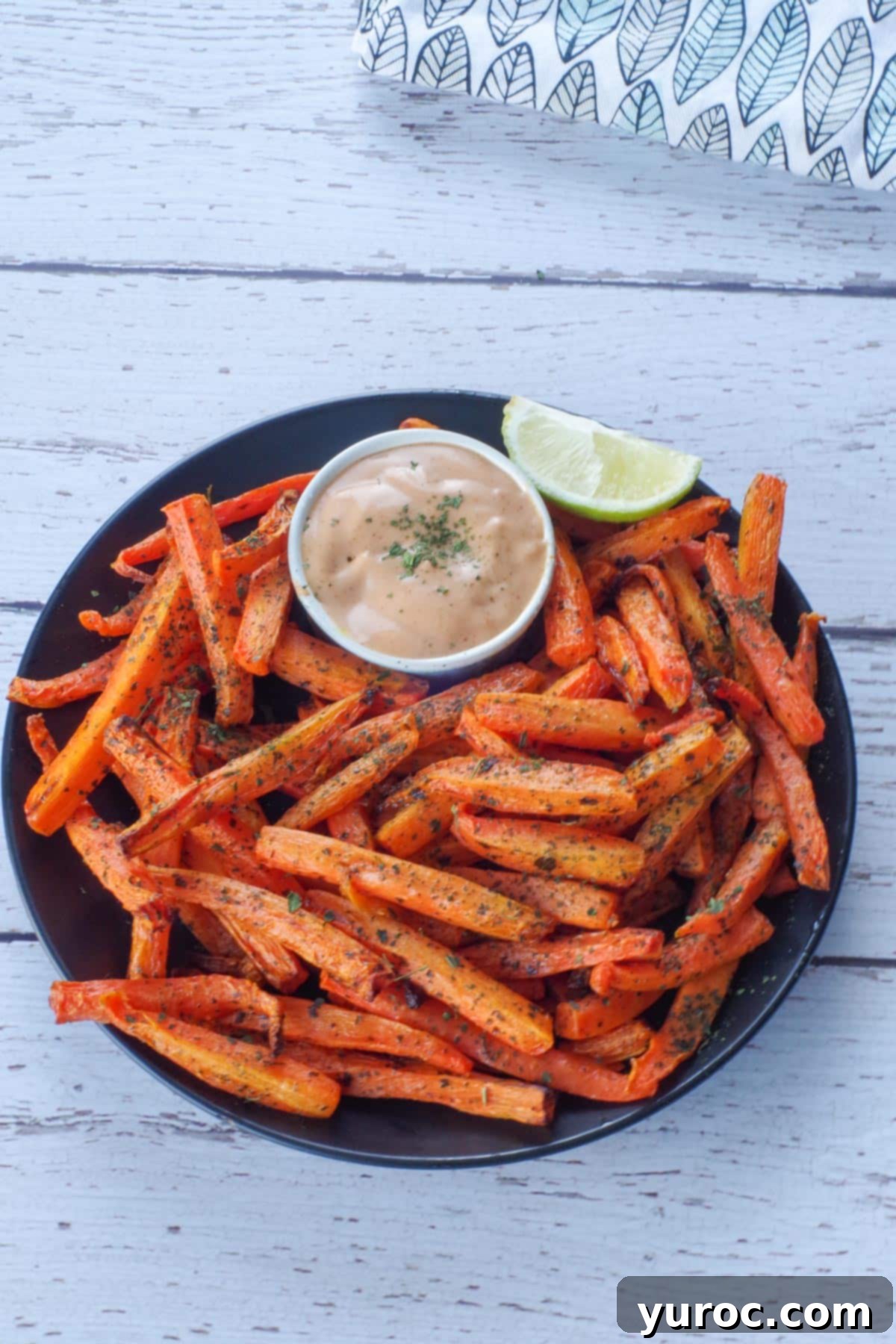 carrot fries and dip on a black plate