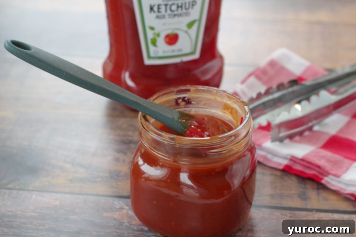 Quick and Easy Ketchup Brown Sugar BBQ Sauce 2 A jar of homemade BBQ sauce made with ketchup and brown sugar, ready for use.