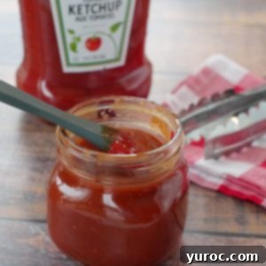 Quick and Easy Ketchup Brown Sugar BBQ Sauce 10 Homemade BBQ sauce with ketchup in a jar, with a ketchup bottle in the background.
