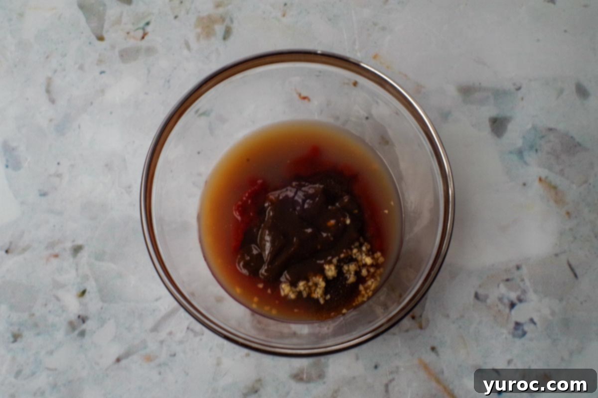 Quick and Easy Ketchup Brown Sugar BBQ Sauce 4 All the ingredients for Barbeque sauce with Ketchup and Brown Sugar placed in a single glass bowl, ready to be mixed.