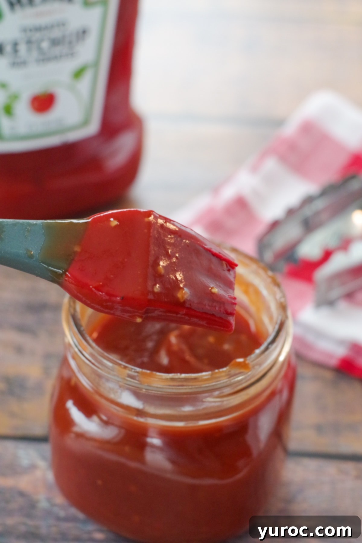 Quick and Easy Ketchup Brown Sugar BBQ Sauce 6 A beautifully presented jar of homemade BBQ sauce with ketchup, with a ketchup bottle softly blurred in the background, ready for use.