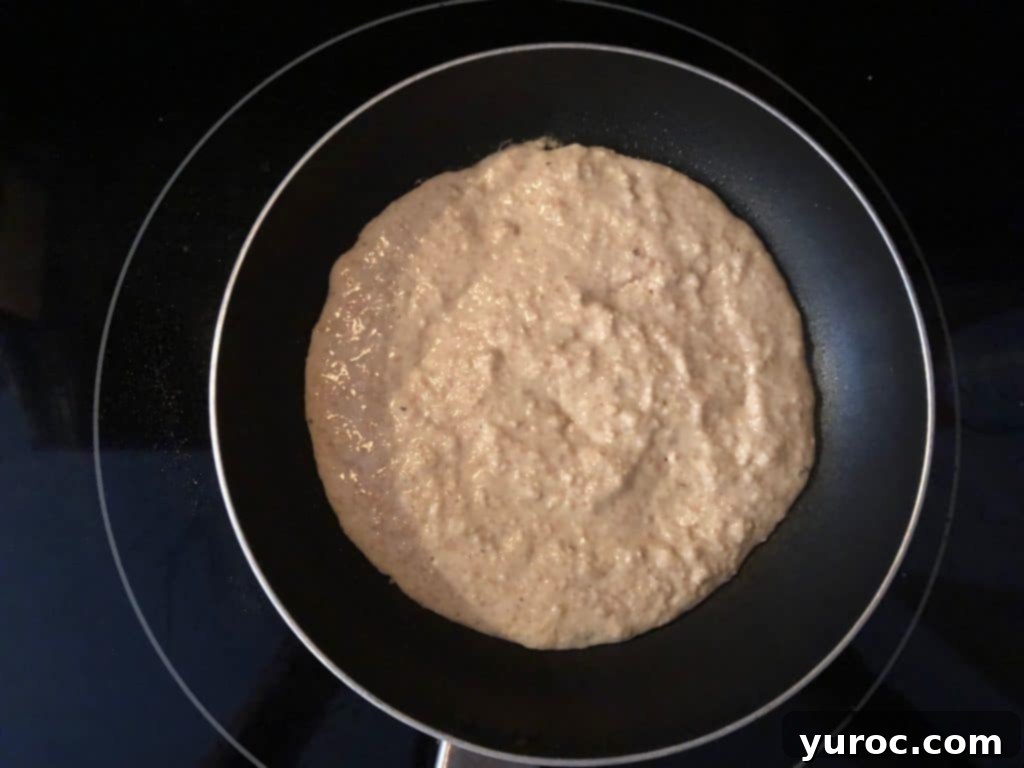 Pancake batter cooking in a frying pan