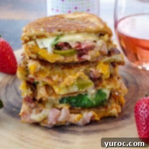 Strawberry Moscato grilled cheese on wooden tree platter with glass of moscato in background and strawberries