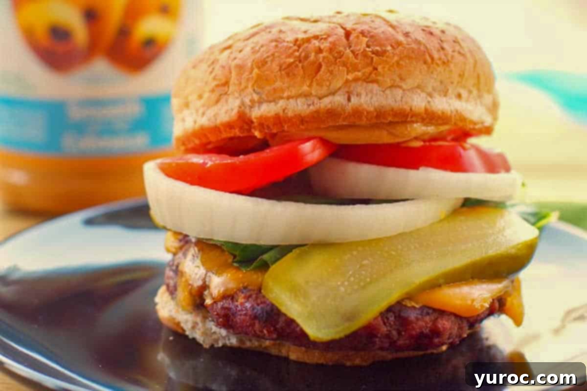 Peanut butter burger on a black plate with a jar of peanut butter in the background.