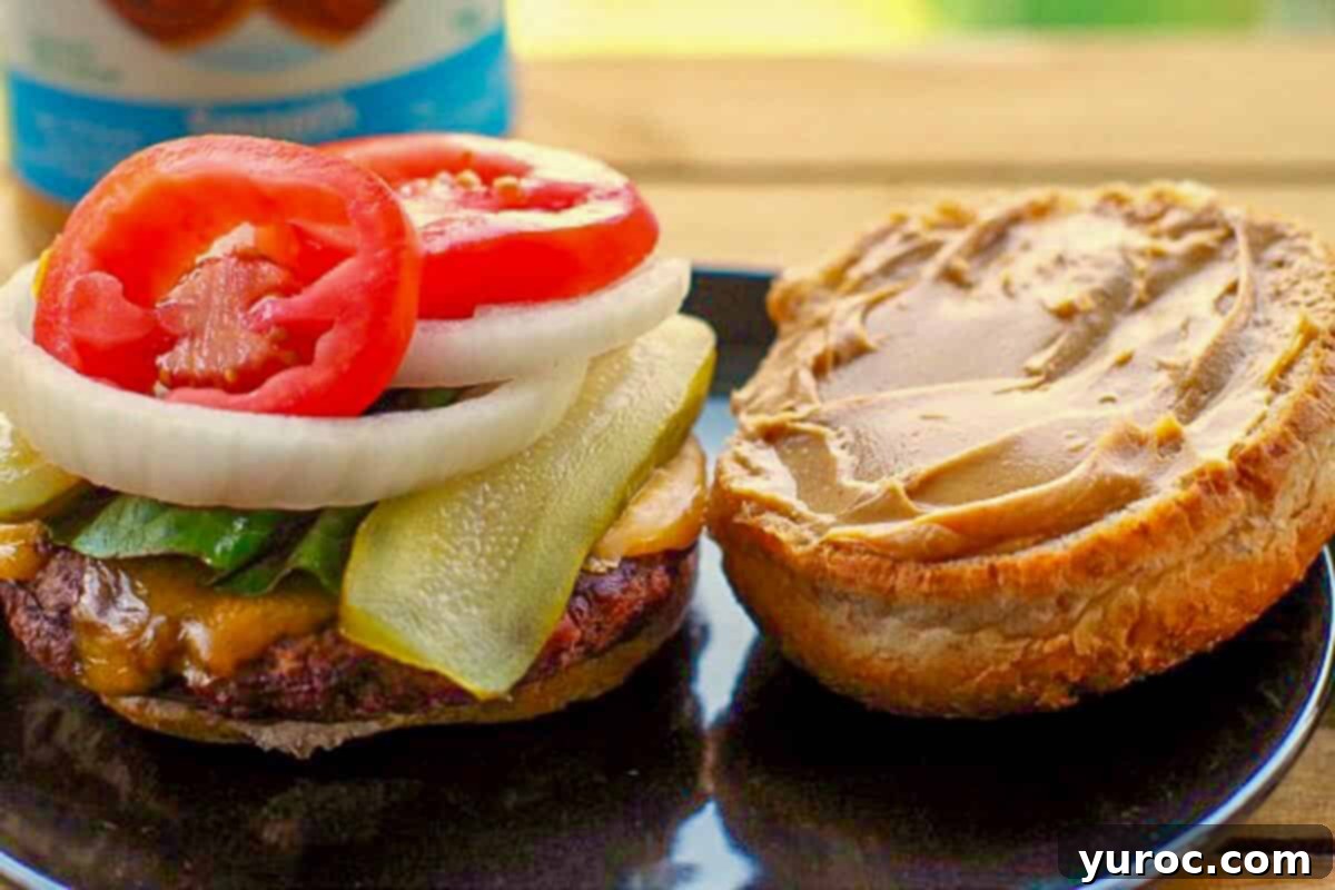 Open Guber burger on a black plate.