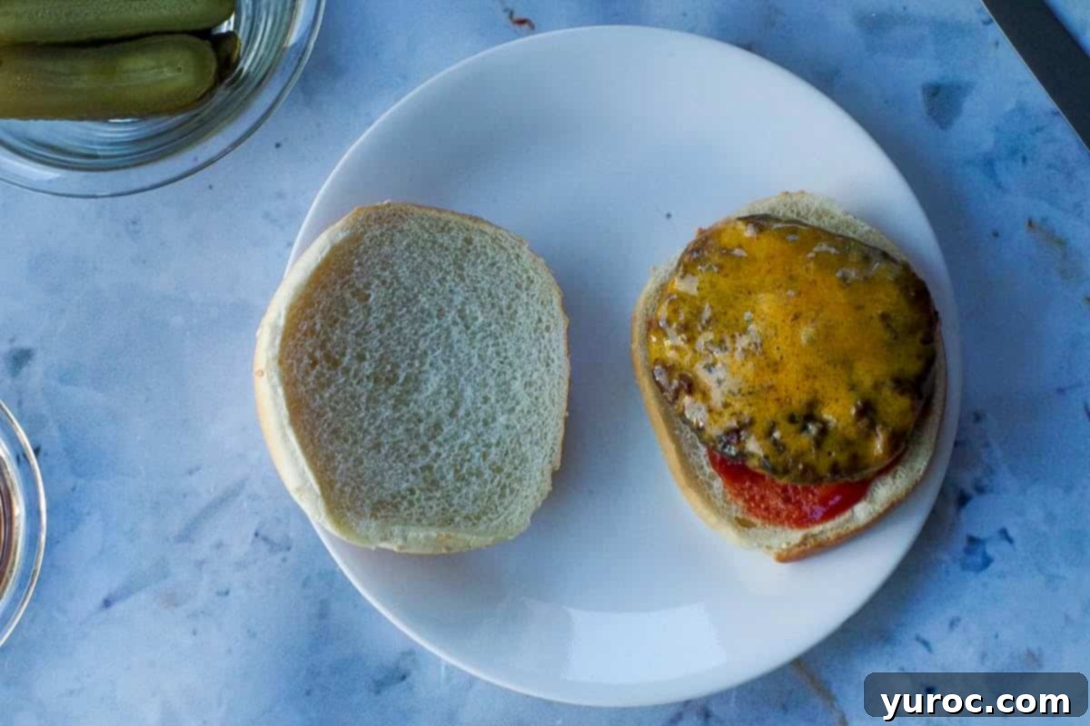 Cheesy patty placed on ketchup side of bun.